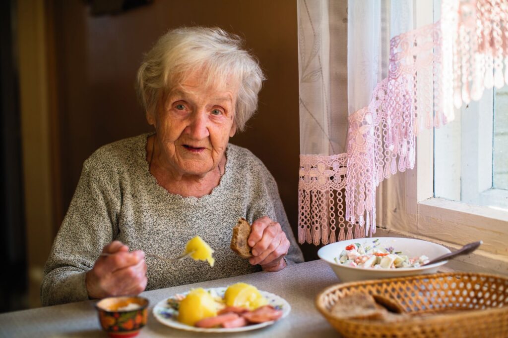 Senior qui se nourrit d'aliments riches en vitamines B, C et D, ainsi qu'en magnésium et en protéines