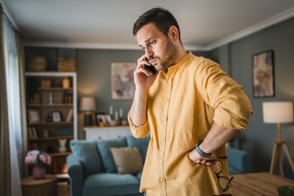 Aidant à distance stressé au téléphone avec le senior aidé