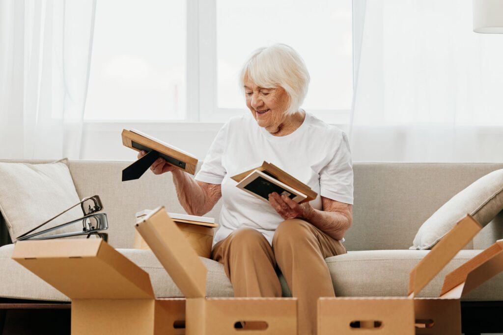 Senior qui emménage en EHPAD avec ses photos de famille et autres objets familiers