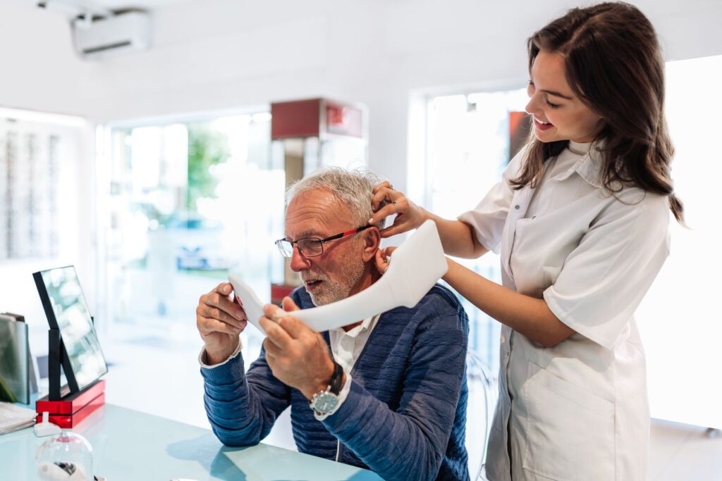 senior faisant un bilan auditif avec un audioprothésiste